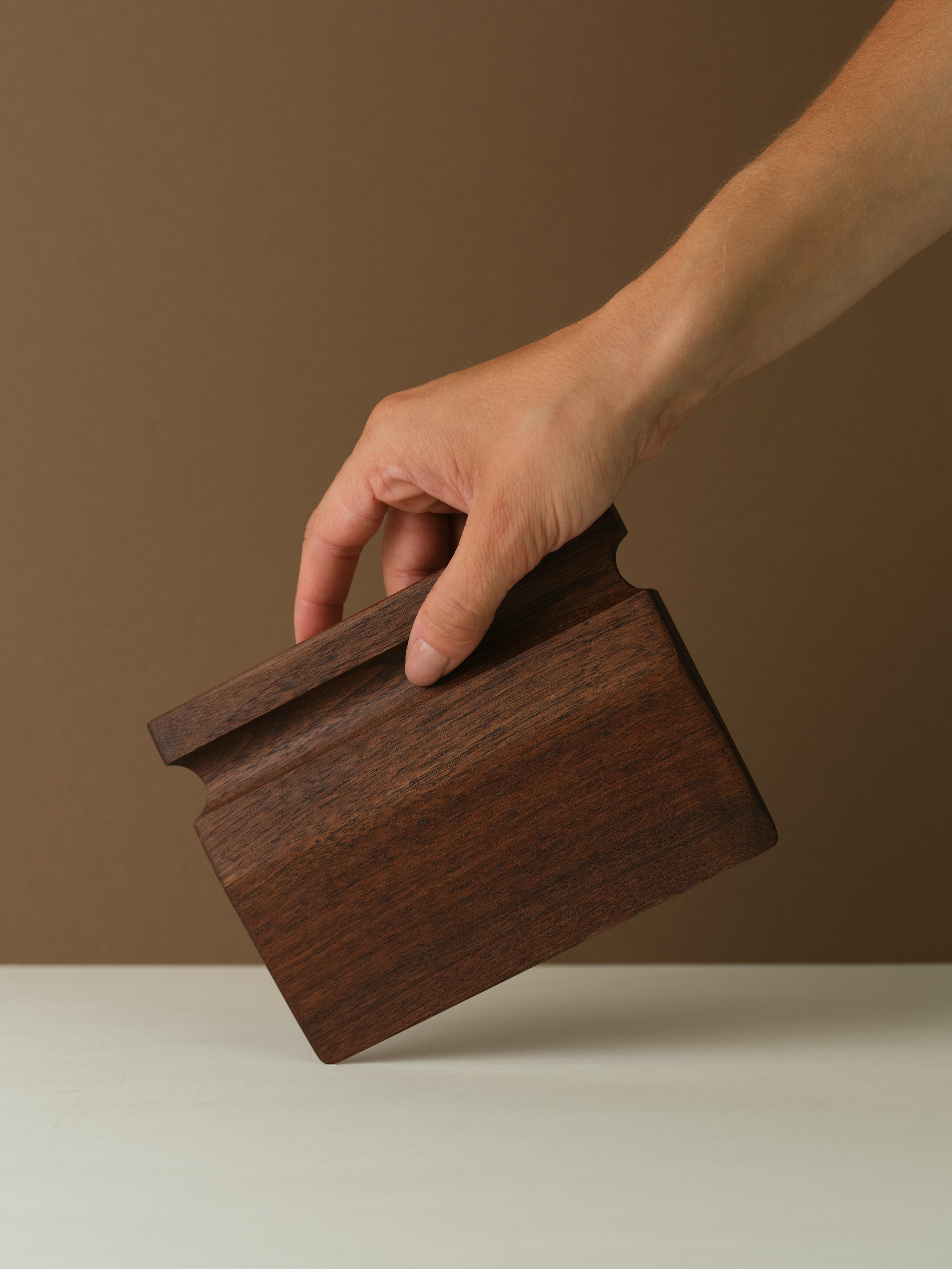 Katto walnut wood dough scraper held at an angle