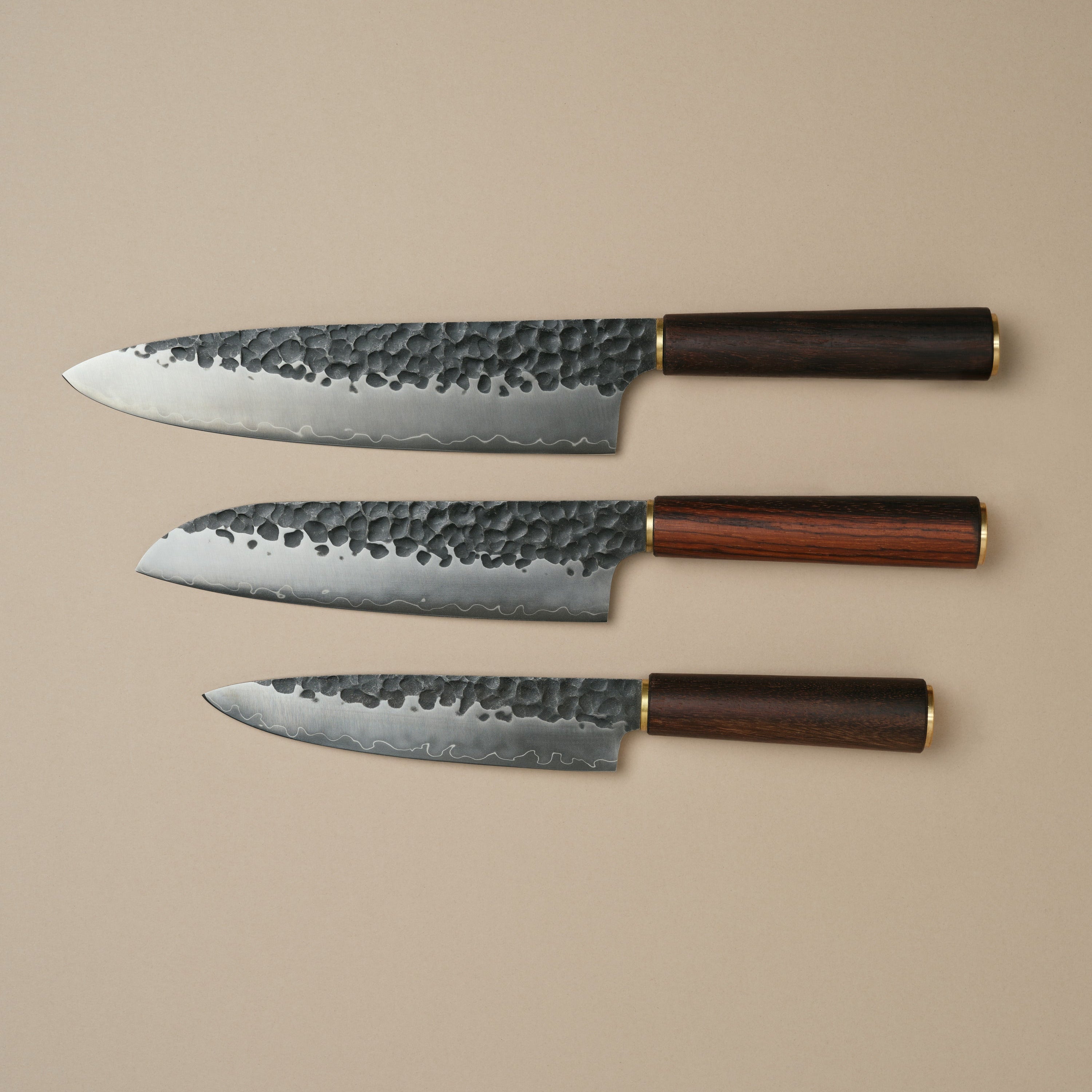 Katto knife set including Chefs Knife, Santoku Knife and Utility Knife, each with a rosewood handle.