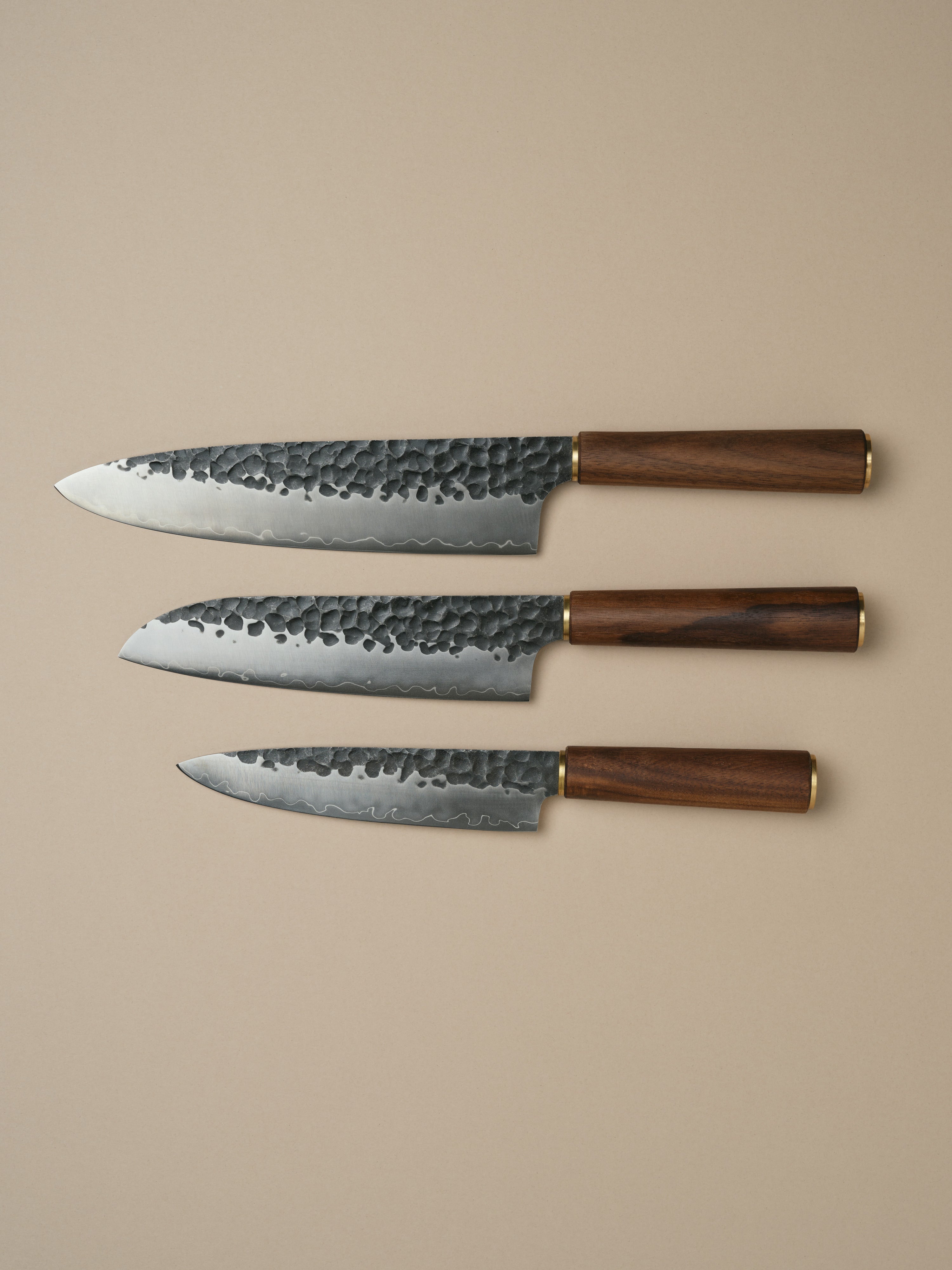 Katto knife set including Chefs Knife, Santoku Knife and Utility Knife, each with a walnut wood handle.